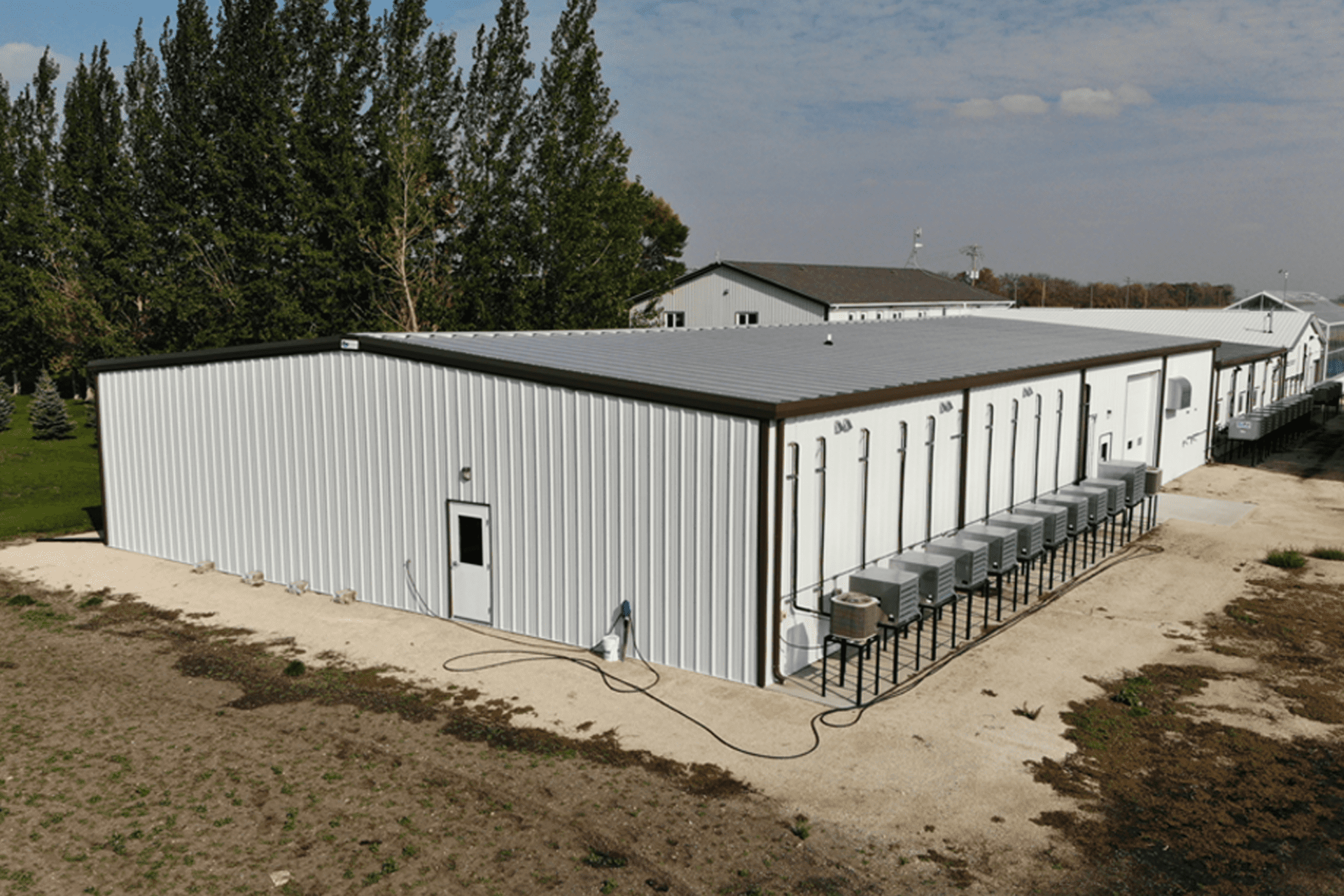 A pre-engineered steel growing facility with several fan units for ventilation