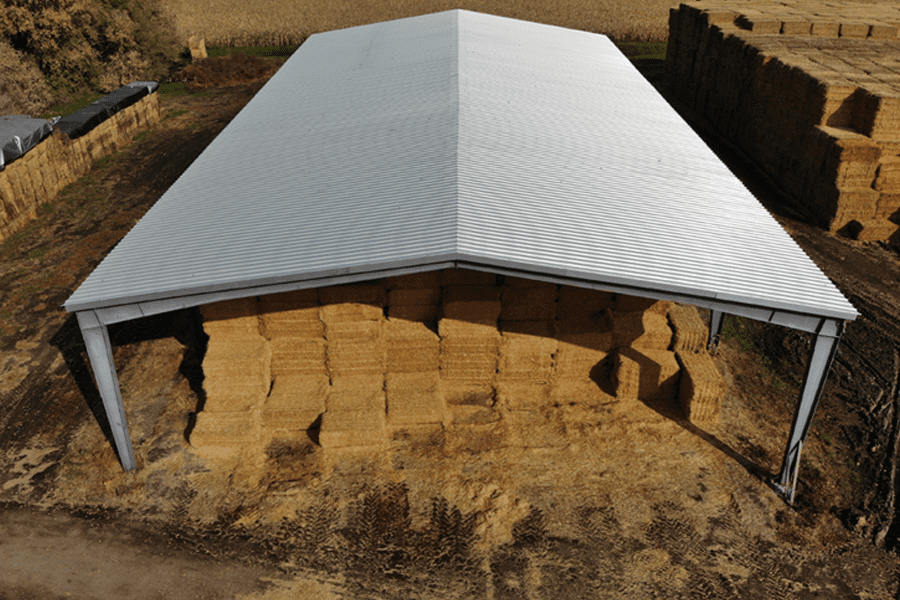 An open-sided pre-engineered steel hay storage structure
